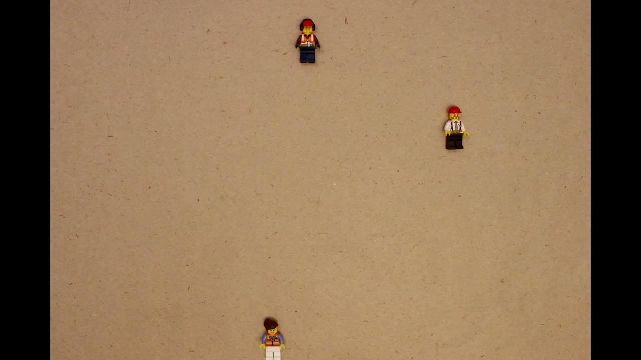 Three toy figures arranged separately on a paper background, from the Joy, Money, Flow video.