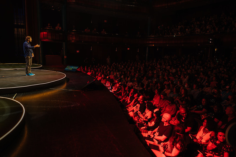 Chris Guillebeau delivering a keynote in a large theater